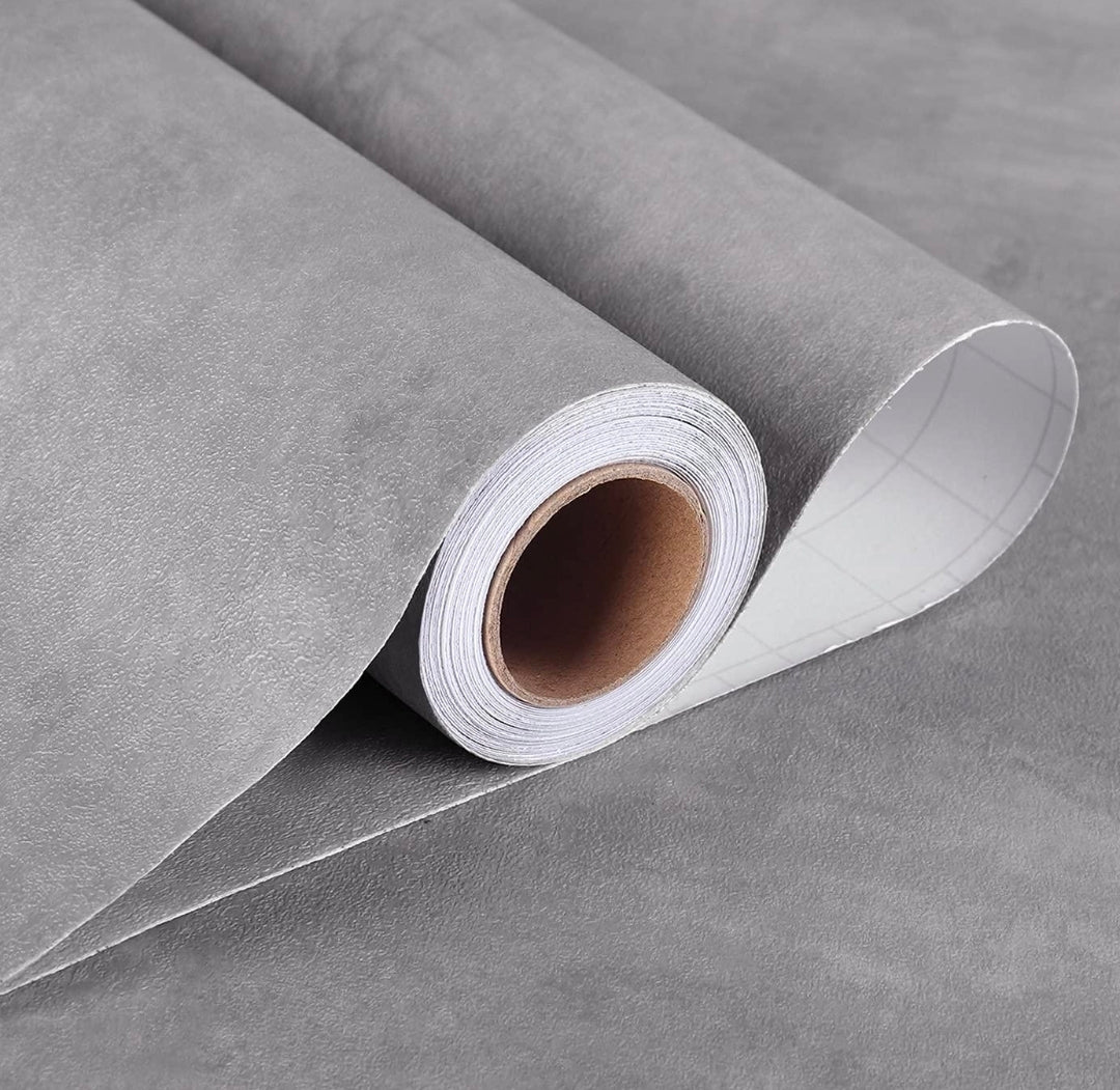 Grey luxurious embossed self-adhesive roll from Budget Interiors, showcasing textured, decorative wall covering or wallpaper.
