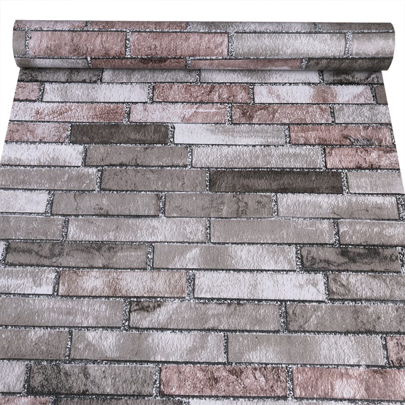 Vintage faux brick peel and stick roll in pink, beige, and grey by Budget Interiors, showing the textured brick pattern on the roll.