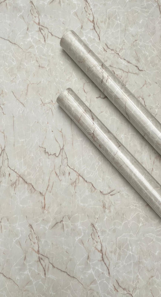 Beige marble slab showing smooth surface and natural veining, from Budget Interiors for interior design and flooring applications.