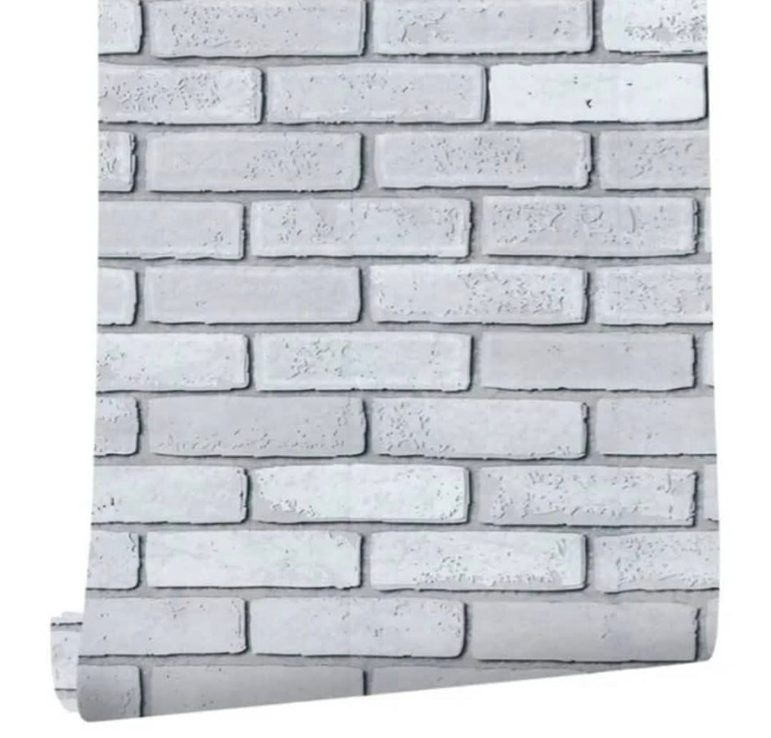 White and grey brick wallpaper by Budget Interiors showing a realistic brick pattern on a wall surface.