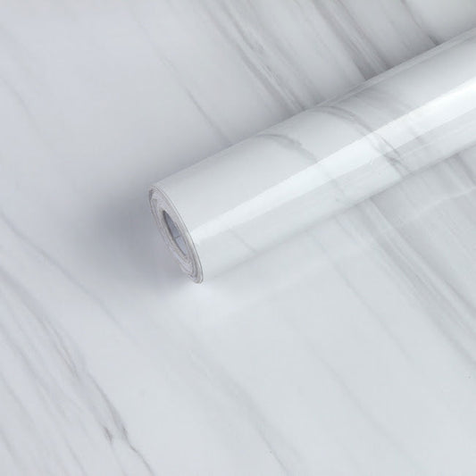 White marble slab by Budget Interiors with natural veining and polished surface, ideal for countertops or decorative accents.
