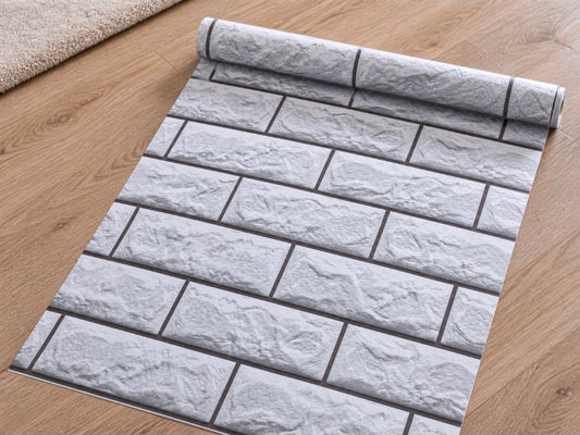 Grey 3D tile effect peel-and-stick wallpaper roll by Budget Interiors, 10 meters long, showing textured tile pattern for wall decor.