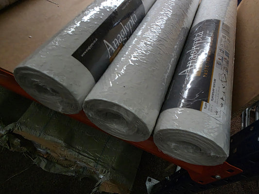 Wood chip wallpaper rolls by Budget Interiors, showing textured brown and beige wood grain pattern for home decor.